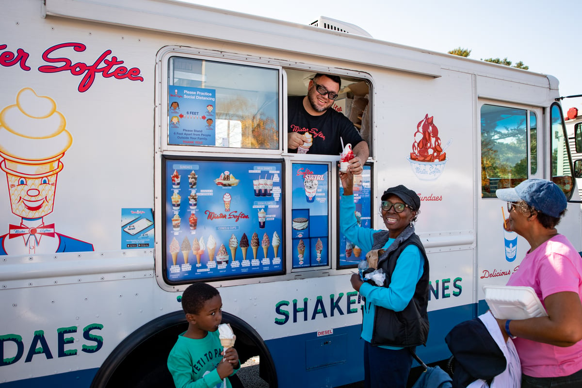 Community members getting ice cream from truck