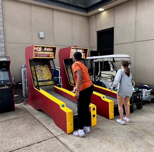 Students playing skee ball