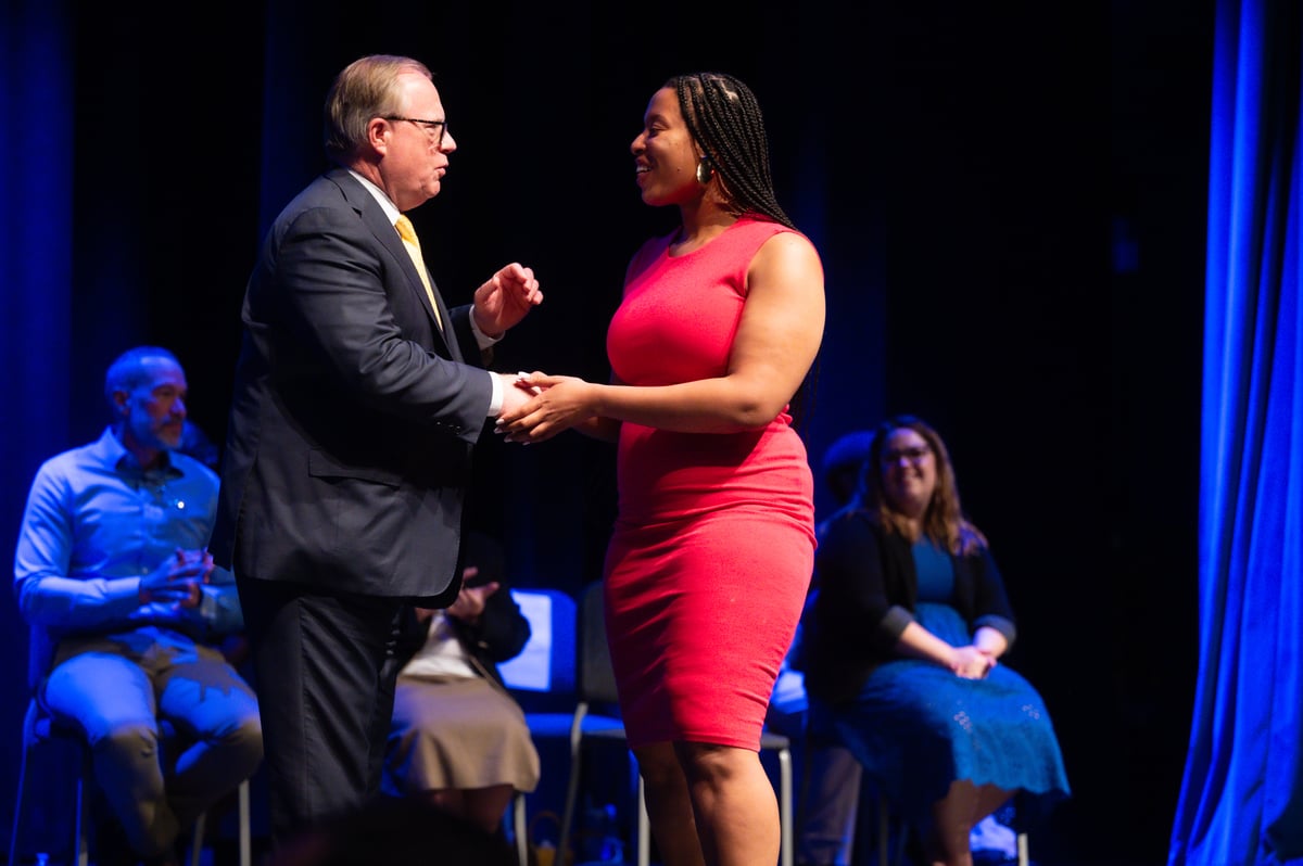 Student shaking Dr. Domes's hand